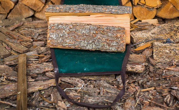 A Firewood Carrier lied flat with wood placed in the center.